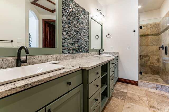 5326 North Oldgate Road Heber City, UT 84032 - Photo 18 of 32 Bathroom featuring a double vanity with light green cabinetry, integrated sinks, and polished stone countertops