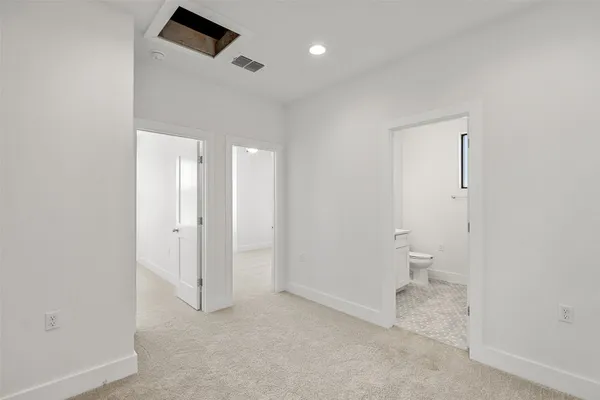 a bathroom with a toilet sink and a mirror