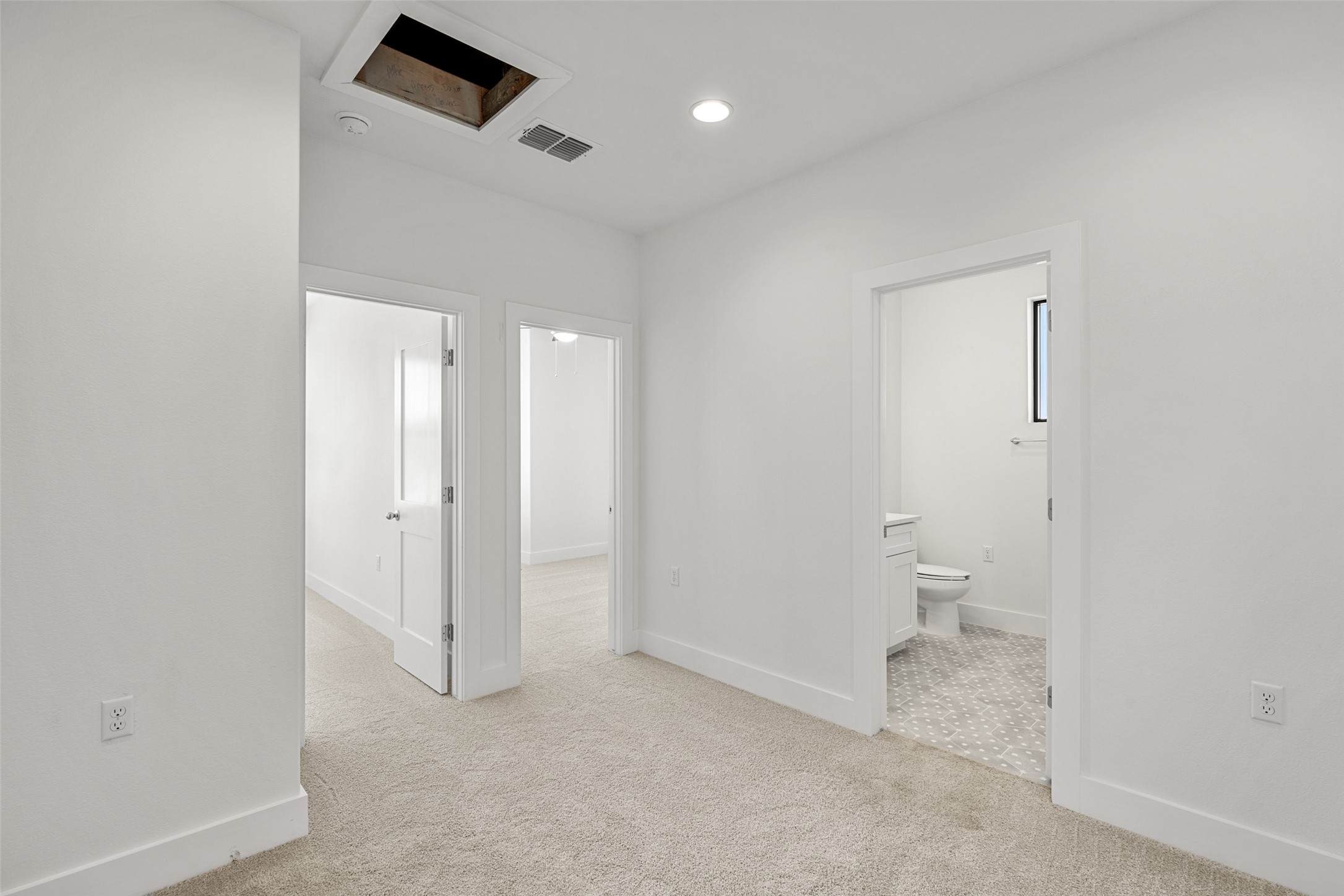 711 Paleface Ranch Road, Unit 3 Spicewood, TX 78669 - Photo 19 of 32 a bathroom with a toilet sink and a mirror