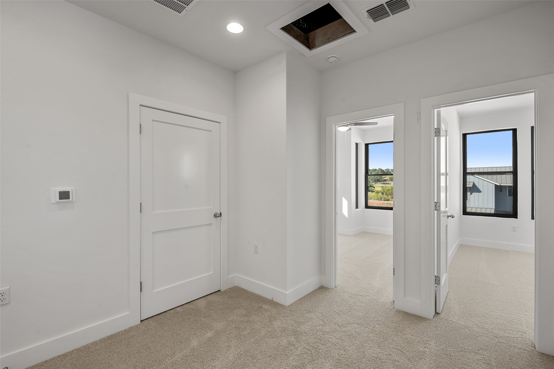 711 Paleface Ranch Road, Unit 3 Spicewood, TX 78669 - Photo 20 of 32 an empty room with windows and closet