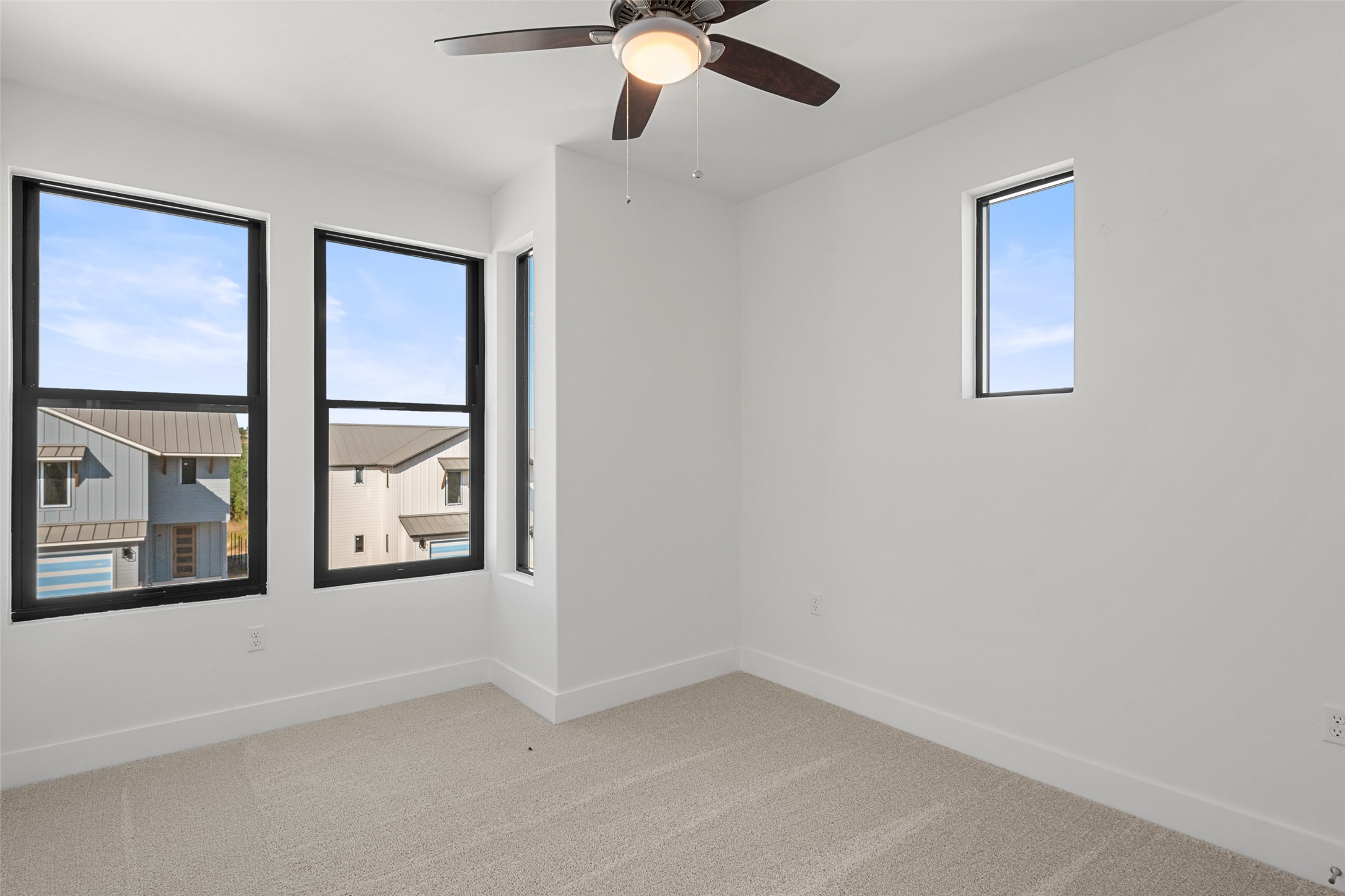 711 Paleface Ranch Road, Unit 3 Spicewood, TX 78669 - Photo 24 of 32 an empty room with windows and fan