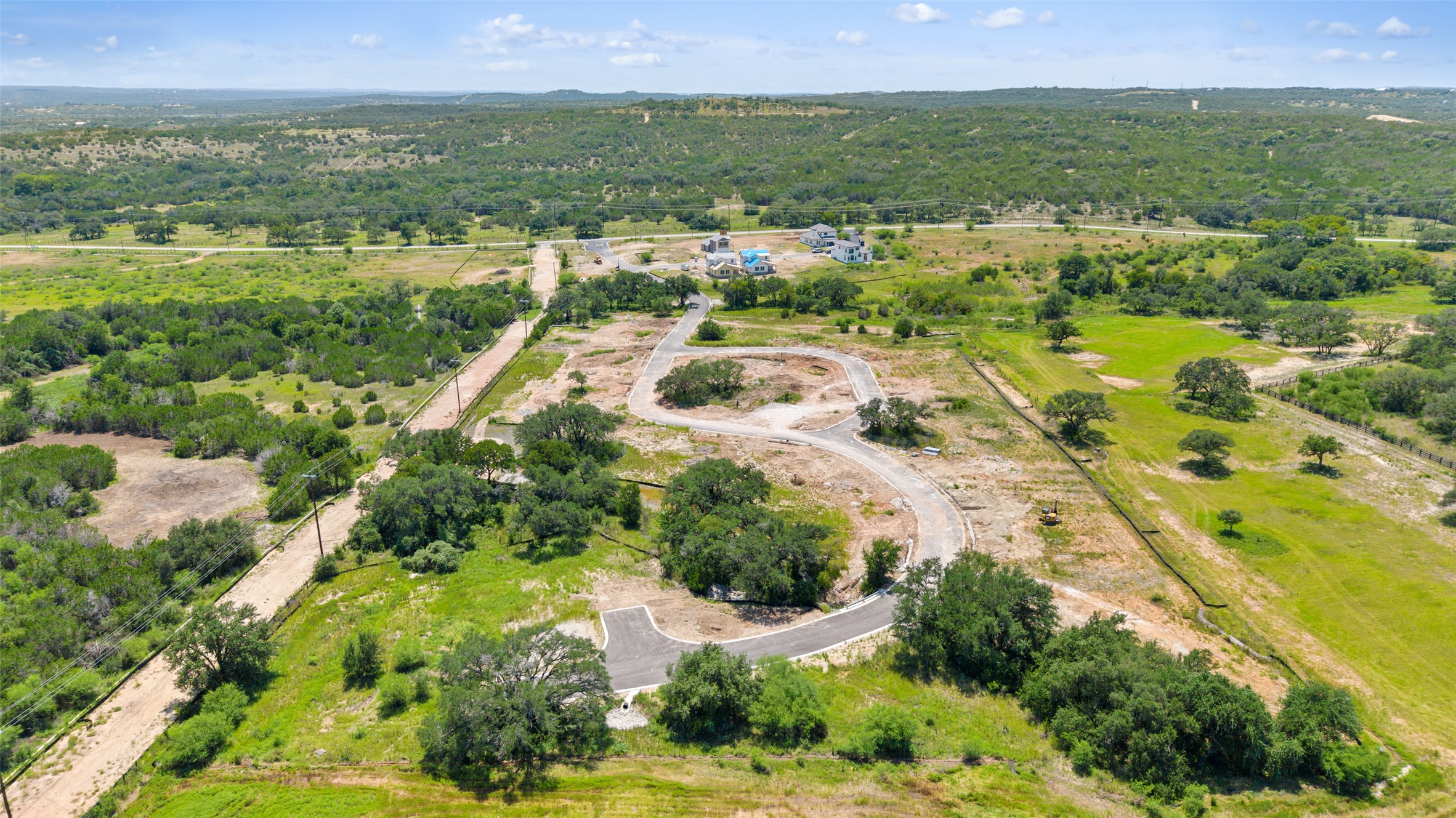 711 Paleface Ranch Road, Unit 3 Spicewood, TX 78669 - Photo 32 of 32 an aerial view of residential houses with outdoor space and trees