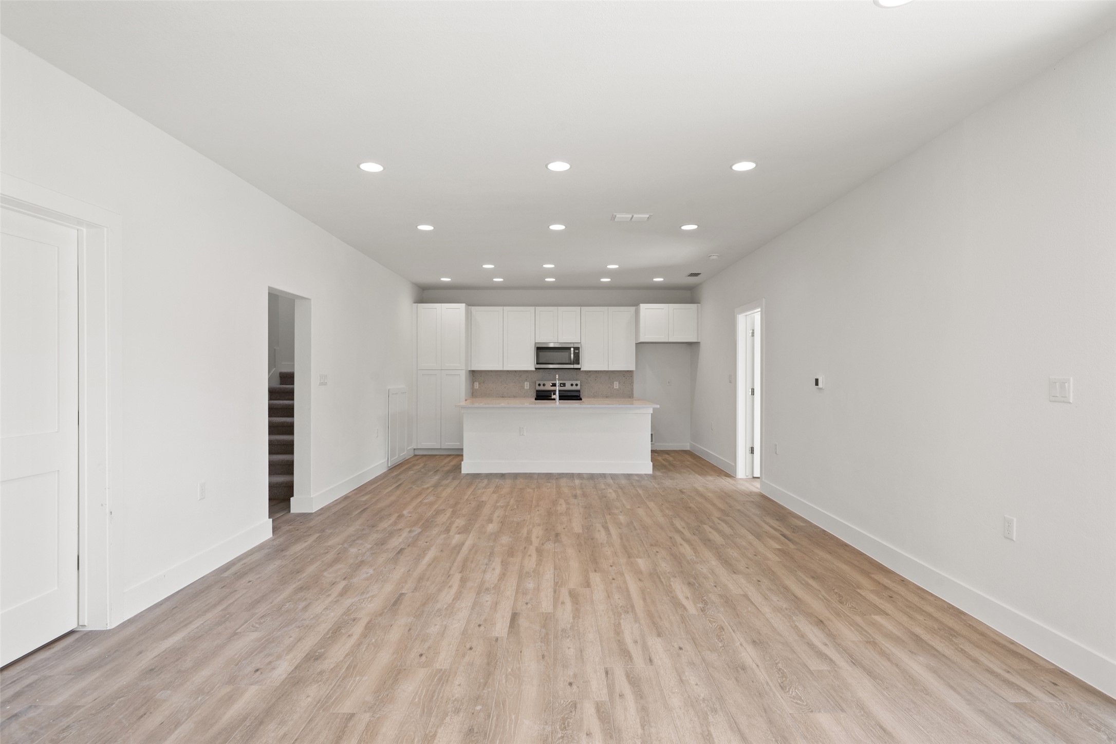 711 Paleface Ranch Road, Unit 3 Spicewood, TX 78669 - Photo 5 of 32 a view of a kitchen with a sink and dishwasher a refrigerator with wooden floor