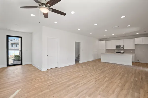 a view of kitchen with refrigerator and window