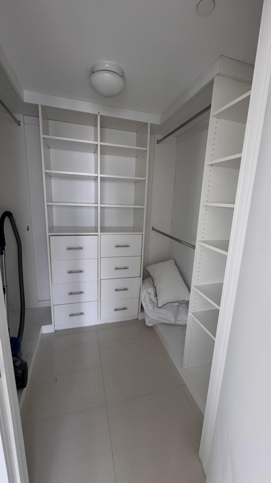 475 Brickell Avenue, Unit 4615 Miami, FL 33131 - Photo 12 of 13 a view of walk in closet with empty racks