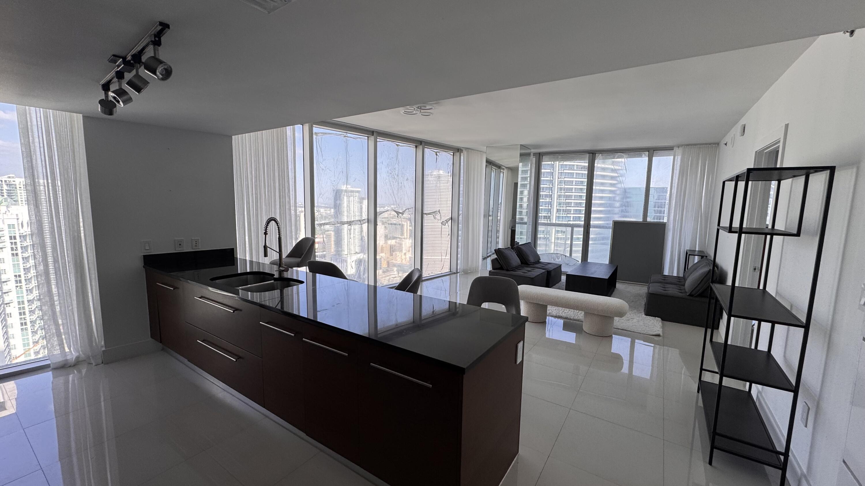 475 Brickell Avenue, Unit 4615 Miami, FL 33131 - Photo 5 of 13 a living room with furniture and large windows