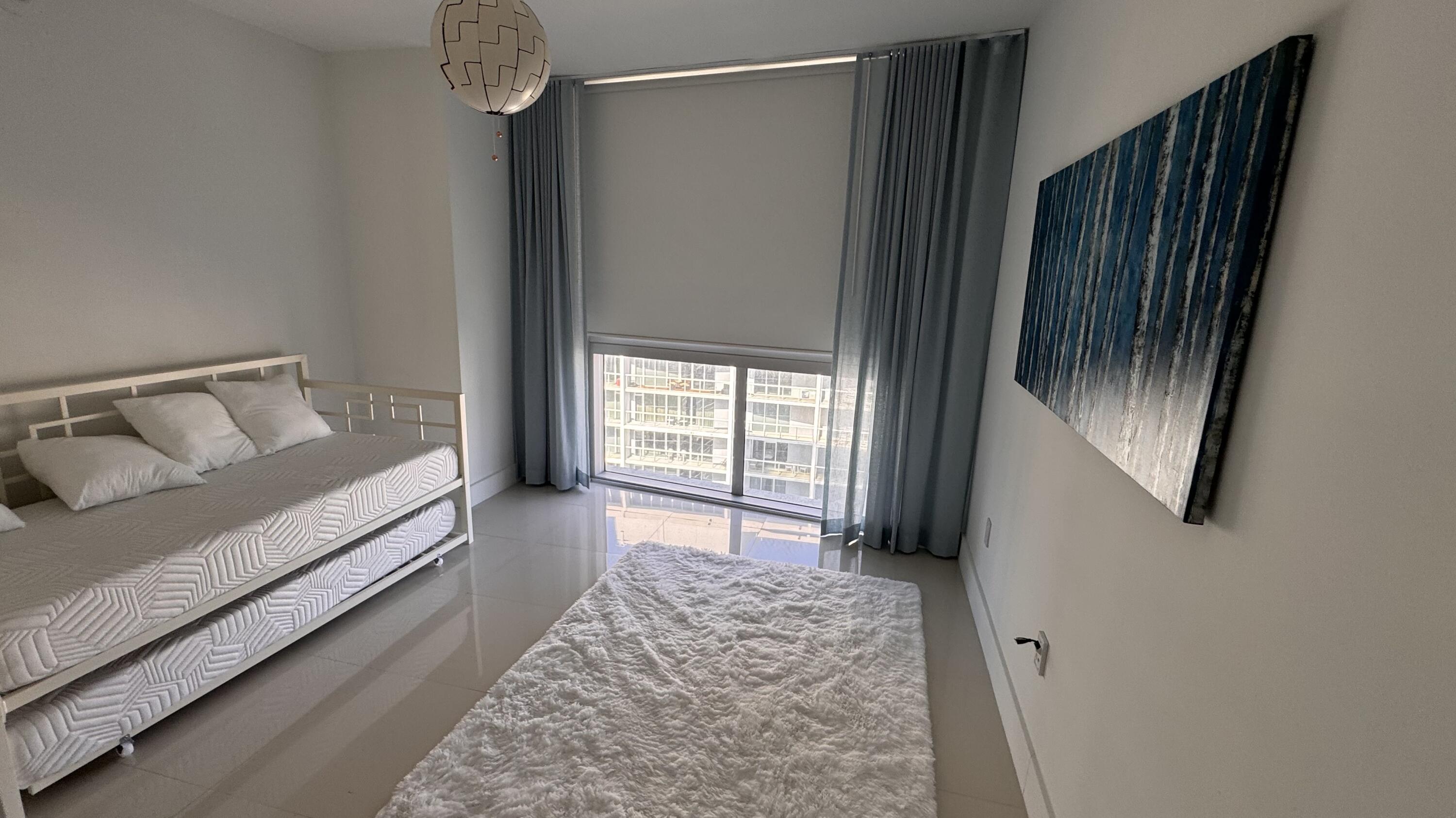 475 Brickell Avenue, Unit 4615 Miami, FL 33131 - Photo 7 of 13 a bedroom with a bed and a window