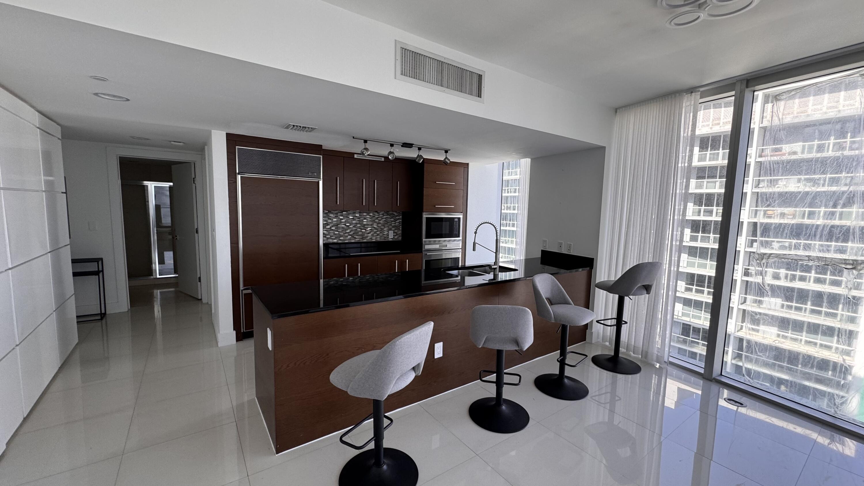 475 Brickell Avenue, Unit 4615 Miami, FL 33131 - Photo 8 of 13 a living room with furniture and a flat screen tv