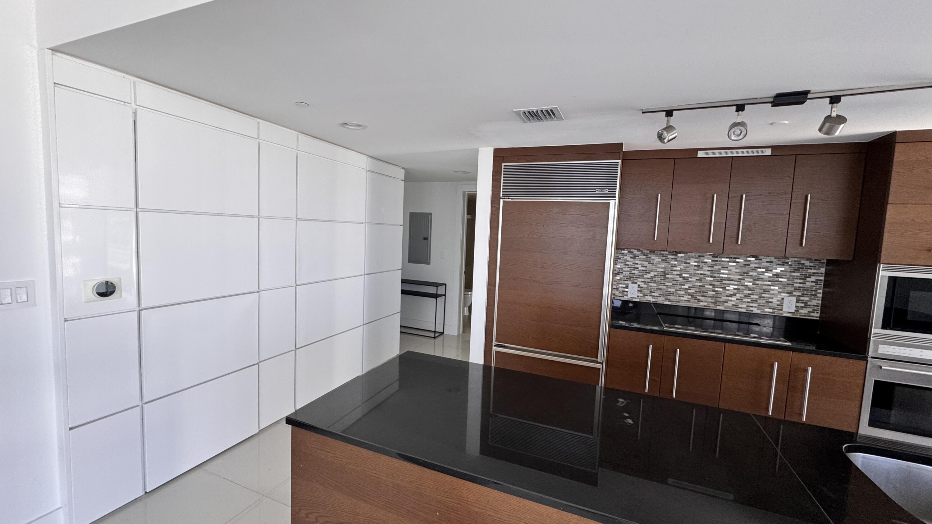475 Brickell Avenue, Unit 4615 Miami, FL 33131 - Photo 9 of 13 a kitchen with granite countertop a refrigerator and a stove