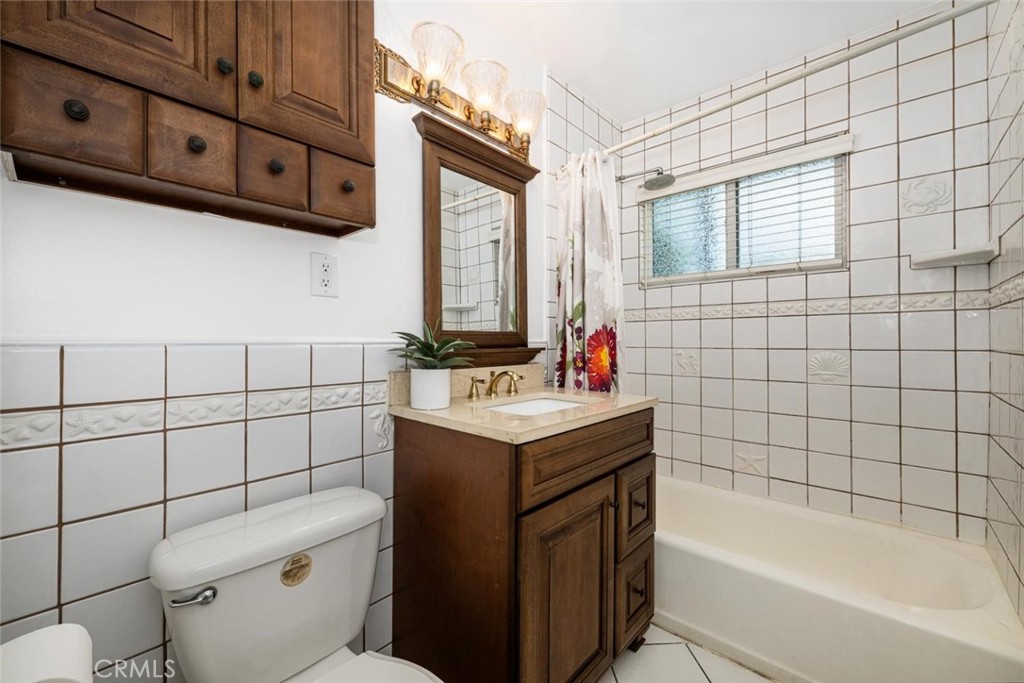 1238 North Studebaker Road Long Beach, CA 90815 - Photo 28 of 47 a bathroom with a sink toilet vanity and tub