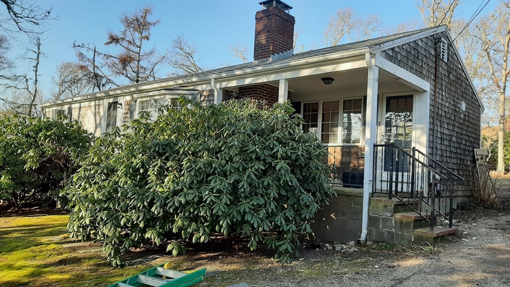 8 Paddock Drive Harwich, MA 02645 - Photo 2 of 12 a front view of a house with garden
