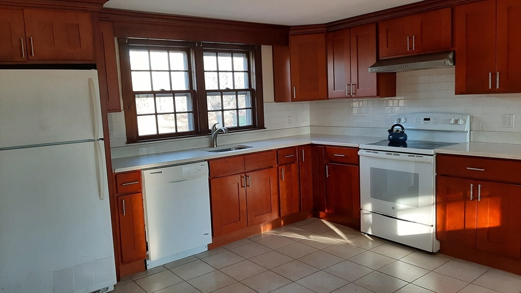 8 Paddock Drive Harwich, MA 02645 - Photo 4 of 12 a kitchen with stainless steel appliances granite countertop a refrigerator and a sink