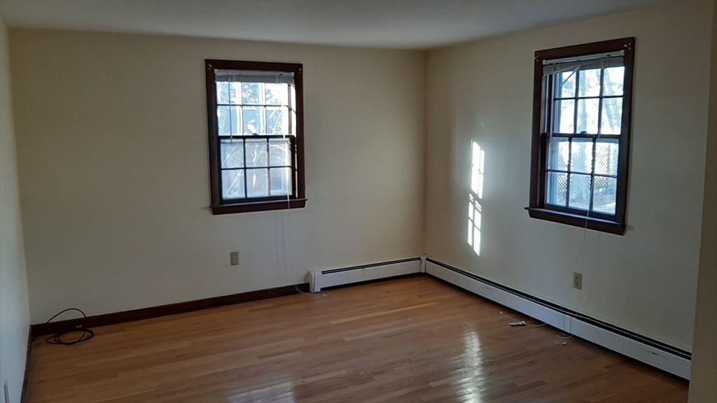 8 Paddock Drive Harwich, MA 02645 - Photo 9 of 12 an empty room with wooden floor and windows