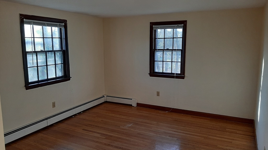 8 Paddock Drive Harwich, MA 02645 - Photo 10 of 12 a view of an empty room with wooden floor and windows