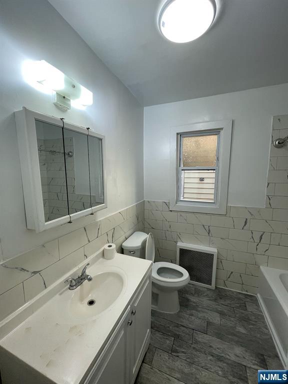 388-390 Leslie Street, Unit 1 Newark, NJ 07112 - Photo 12 of 21 a bathroom with a sink toilet and mirror