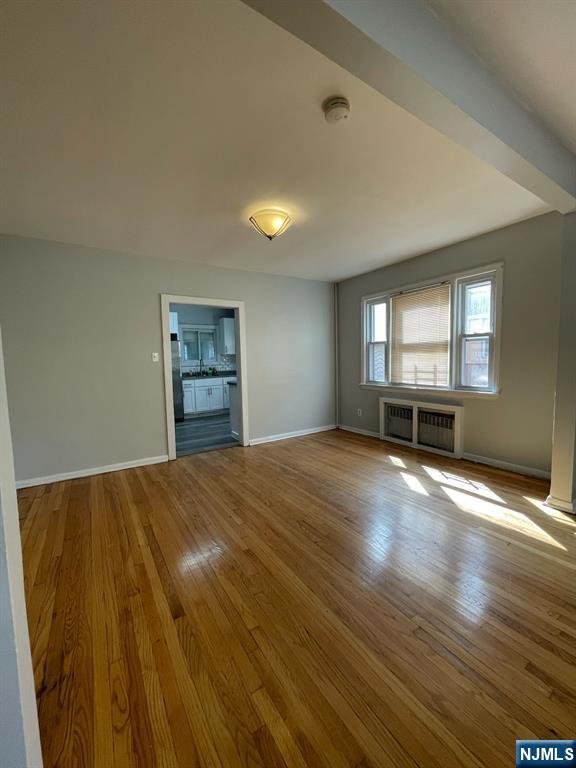 388-390 Leslie Street, Unit 1 Newark, NJ 07112 - Photo 14 of 21 a view of empty room with a windows and wooden floor