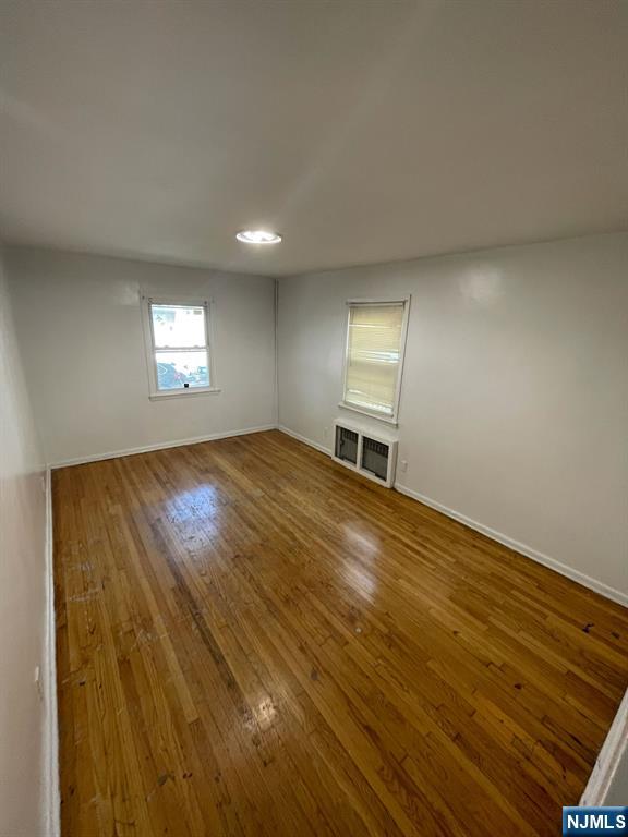 388-390 Leslie Street, Unit 1 Newark, NJ 07112 - Photo 15 of 21 wooden floor in an empty room with a window