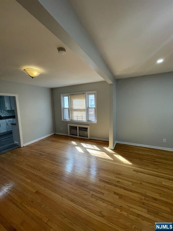 388-390 Leslie Street, Unit 1 Newark, NJ 07112 - Photo 16 of 21 a view of empty room with wooden floor and fan