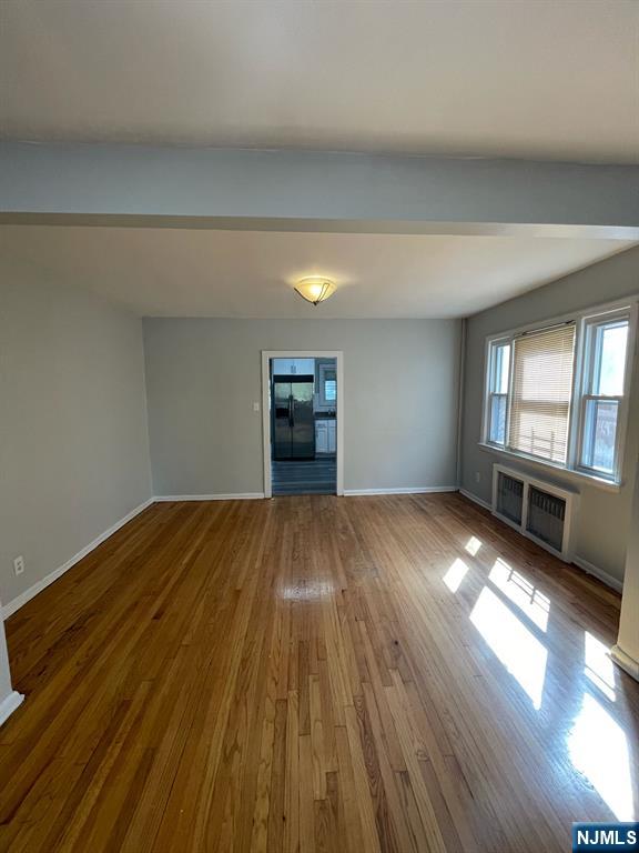 388-390 Leslie Street, Unit 1 Newark, NJ 07112 - Photo 17 of 21 a view of empty room with wooden floor and fan