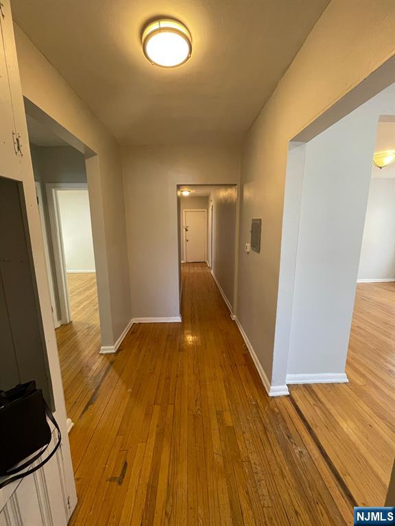 388-390 Leslie Street, Unit 1 Newark, NJ 07112 - Photo 5 of 21 a view of a room with wooden floor and staircase