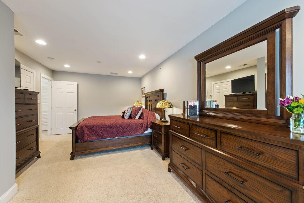 501 Abby Road Middletown, NJ 07748 - Photo 23 of 36 a man sitting on a bed in a hotel room