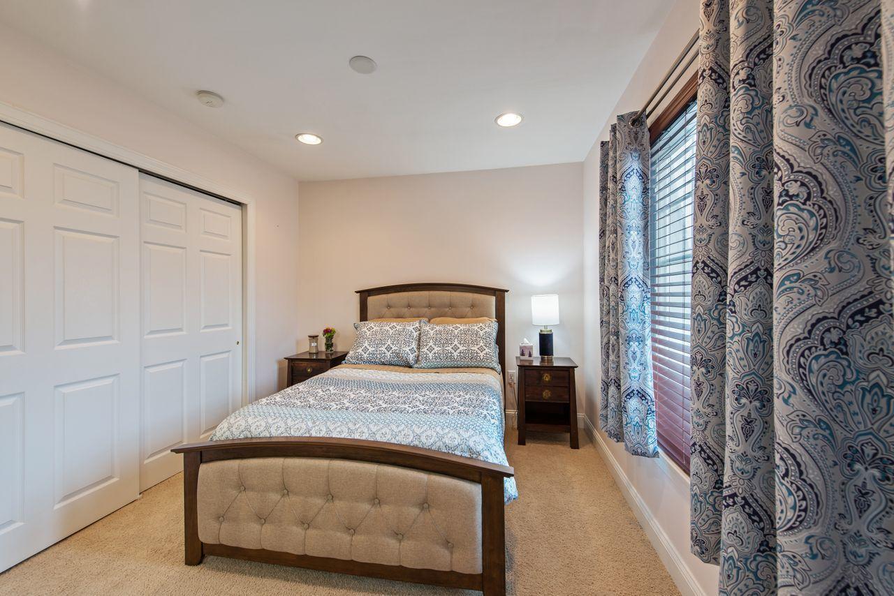 501 Abby Road Middletown, NJ 07748 - Photo 30 of 36 a bedroom with a bed and a lamp