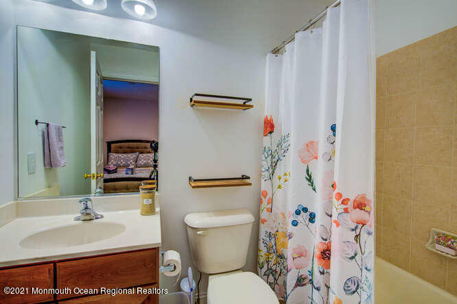 501 Abby Road Middletown, NJ 07748 - Photo 31 of 36 a bathroom with a sink toilet and shower