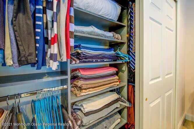 501 Abby Road Middletown, NJ 07748 - Photo 32 of 36 a view of walk in closet with clothes and shoes