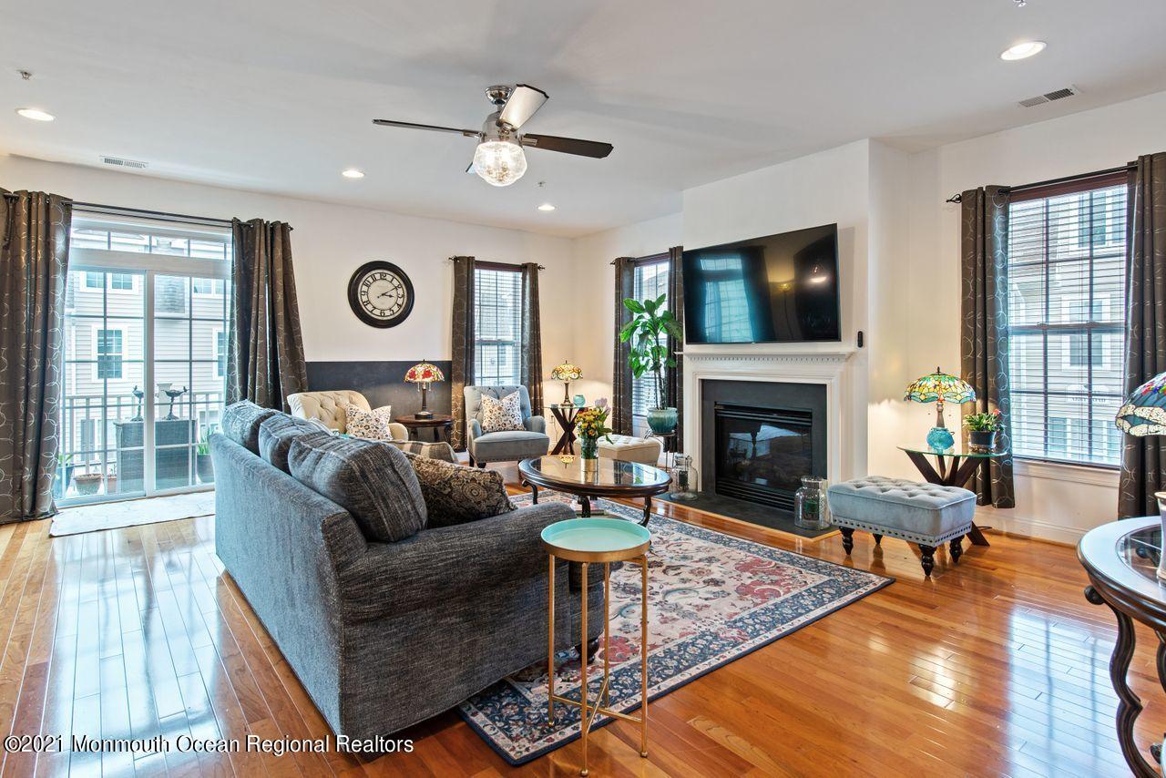 501 Abby Road Middletown, NJ 07748 - Photo 5 of 36 a living room with furniture a fireplace and a large window