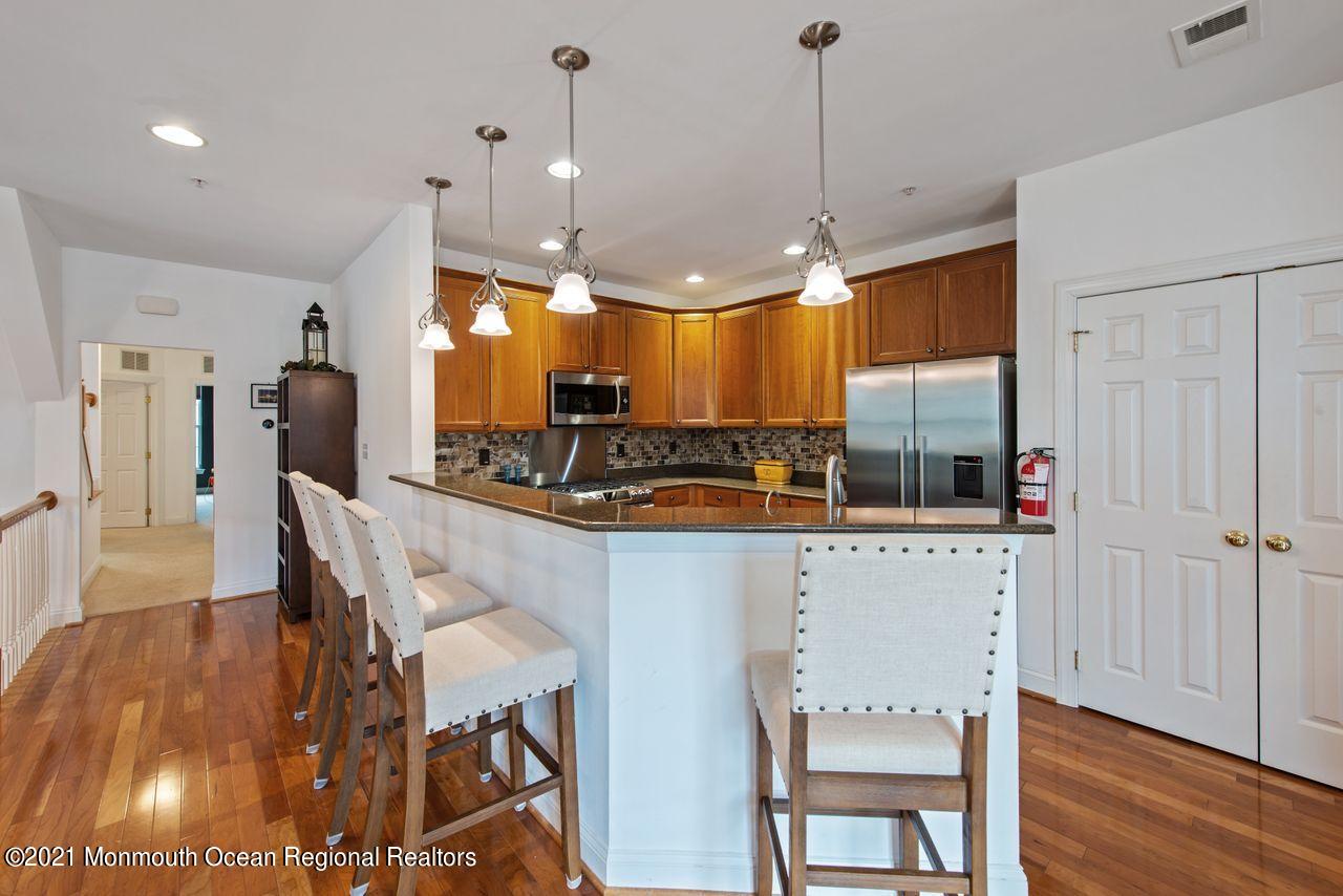 501 Abby Road Middletown, NJ 07748 - Photo 9 of 36 a kitchen with a table chairs refrigerator and cabinets