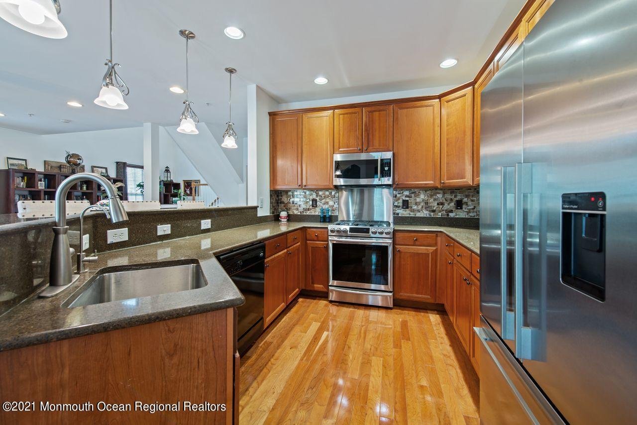 501 Abby Road Middletown, NJ 07748 - Photo 10 of 36 a kitchen with stainless steel appliances kitchen island granite countertop a sink counter space cabinets and a large window
