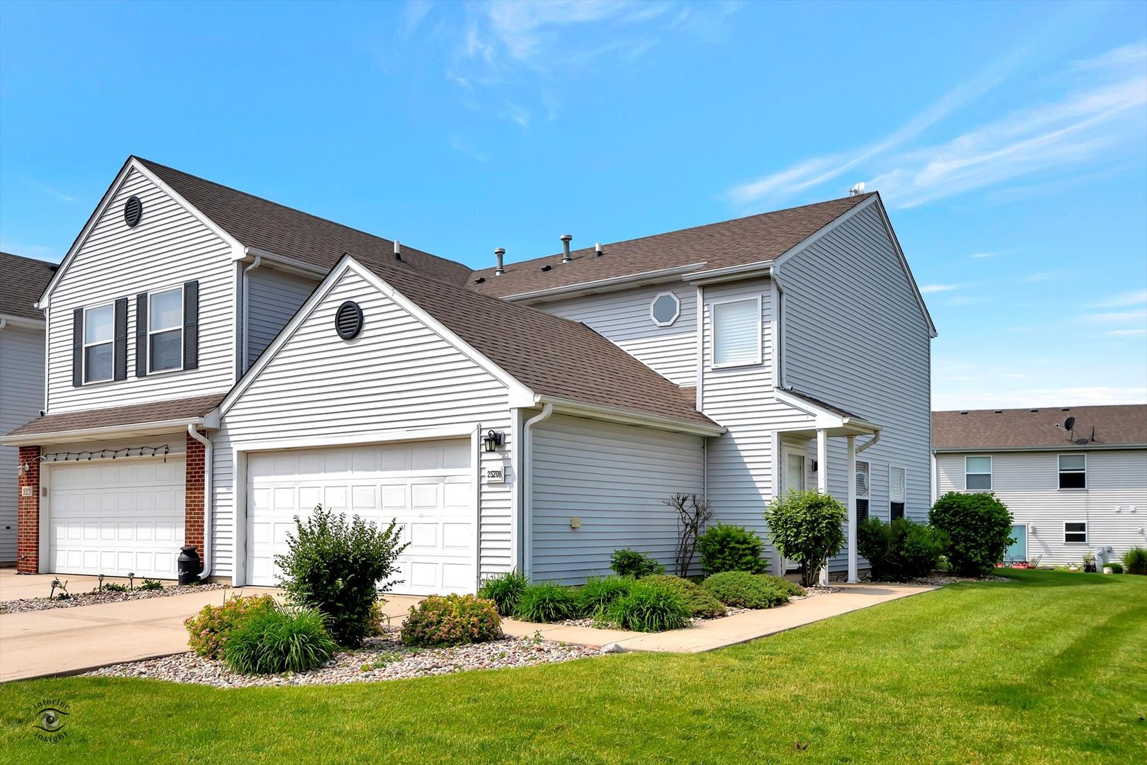 25208 Faraday Road Manhattan, IL 60442 - Photo 1 of 24 a front view of a house with a yard and garage