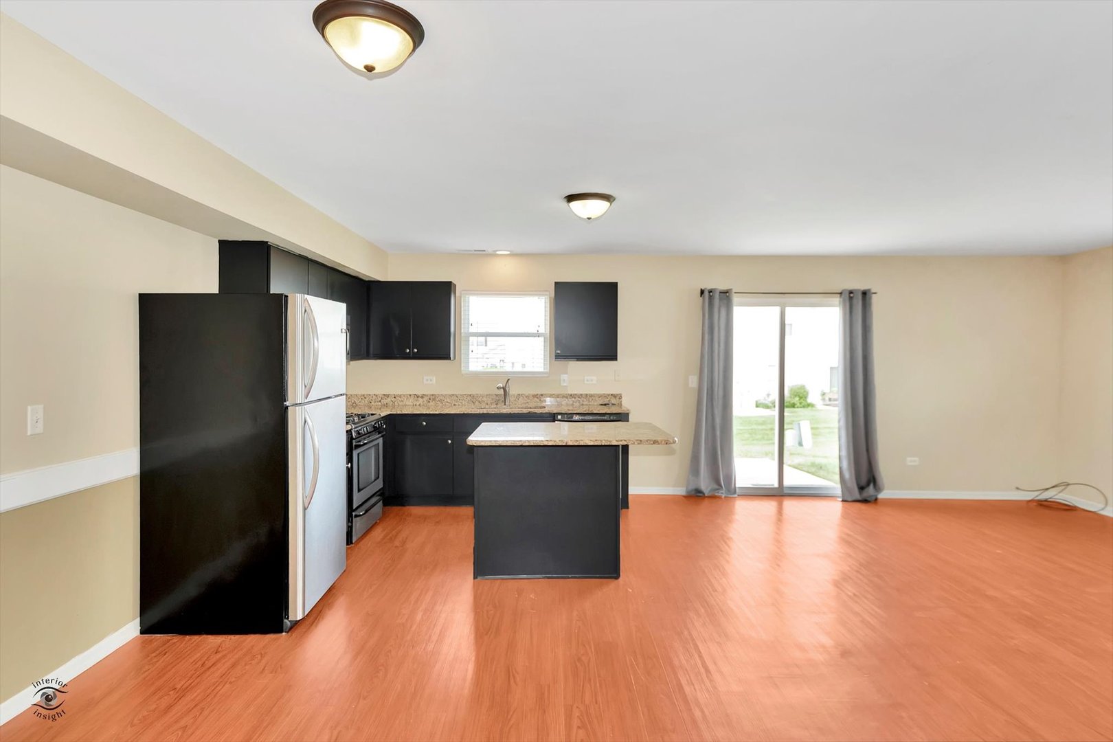 25208 Faraday Road Manhattan, IL 60442 - Photo 13 of 24 a large kitchen with a refrigerator and a stove top oven