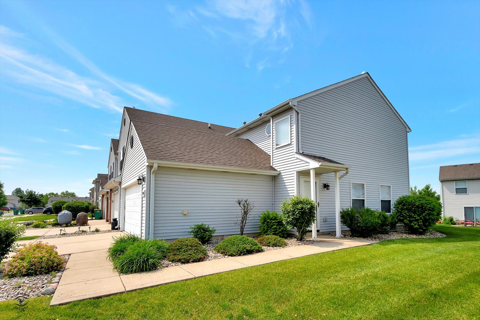 25208 Faraday Road Manhattan, IL 60442 - Photo 2 of 24 a front view of a house with a yard and garage