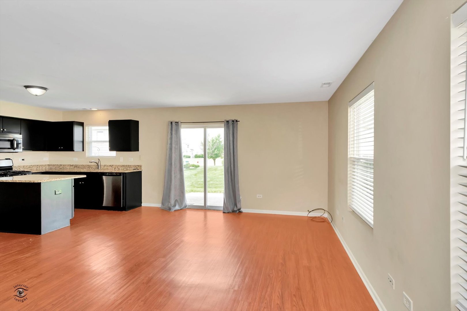 25208 Faraday Road Manhattan, IL 60442 - Photo 6 of 24 a kitchen with stainless steel appliances granite countertop a stove a sink and a microwave