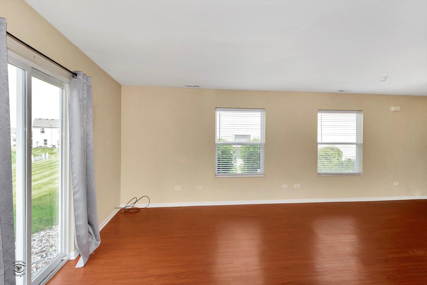 25208 Faraday Road Manhattan, IL 60442 - Photo 8 of 24 a view of an empty room with wooden floor and a window