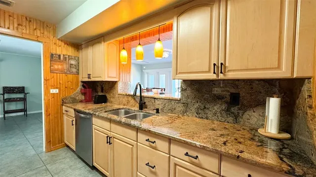 a kitchen with sink and cabinets