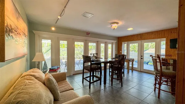 a living room with furniture and large windows