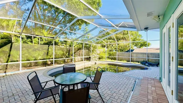 a view of a swimming pool with a patio and a yard