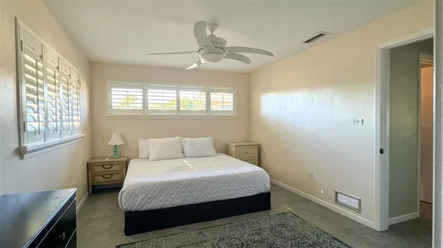 a bedroom with a bed and window