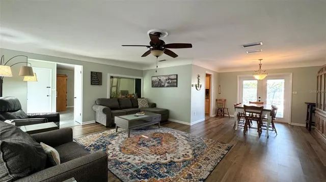 a living room with furniture and wooden floor