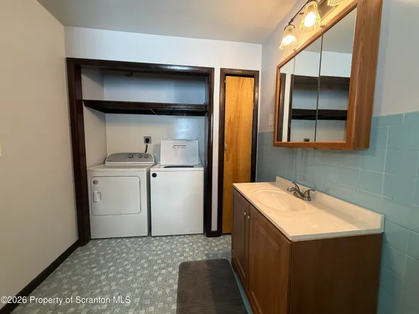 a utility room with a sink dryer and washer