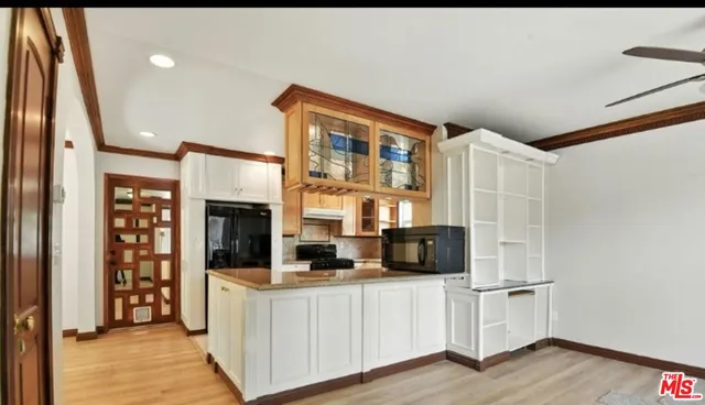 a kitchen with stainless steel appliances a refrigerator and a stove top oven