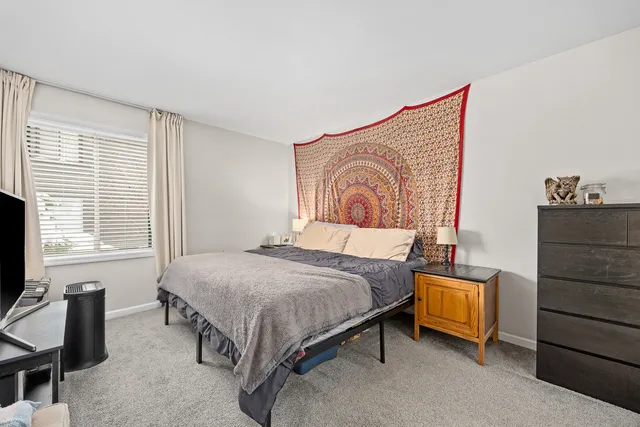 a bedroom with a bed and a dresser in it