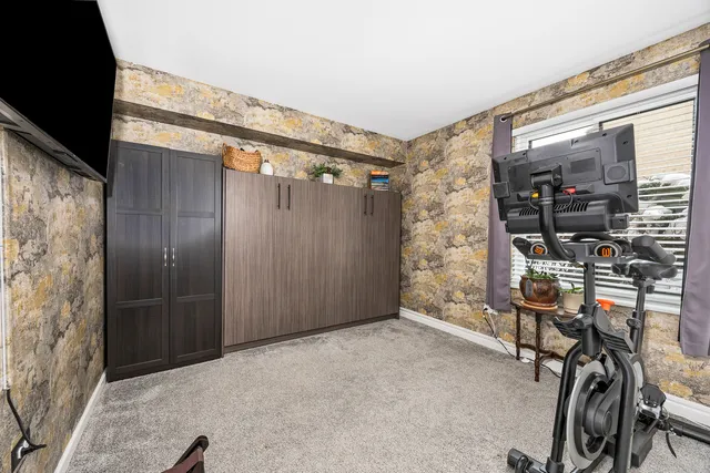 a bedroom with a bed and glass window