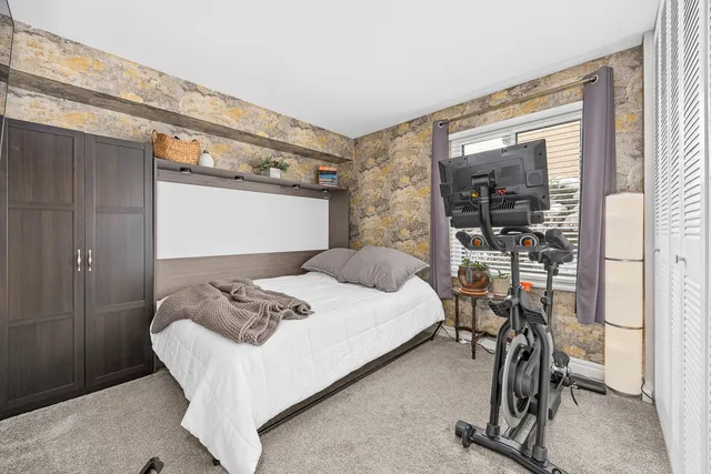 a bathroom with a granite countertop sink toilet and mirror
