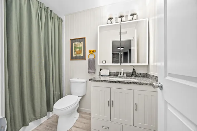 a living room with furniture and a painting on the wall