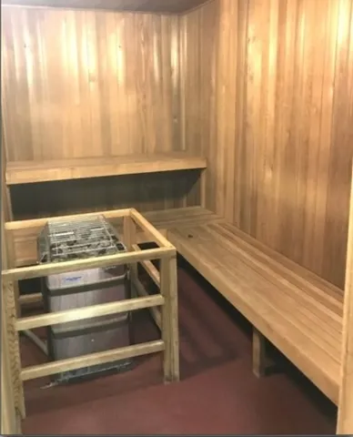 a room with pool table and windows