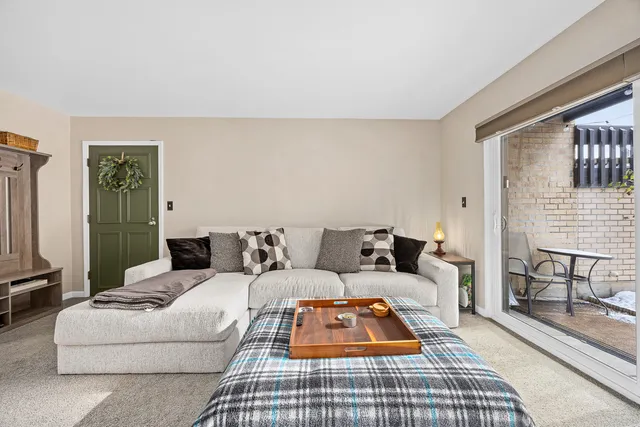 a living room with furniture a rug and a table