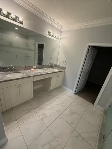 a bathroom with a sink a vanity and mirror